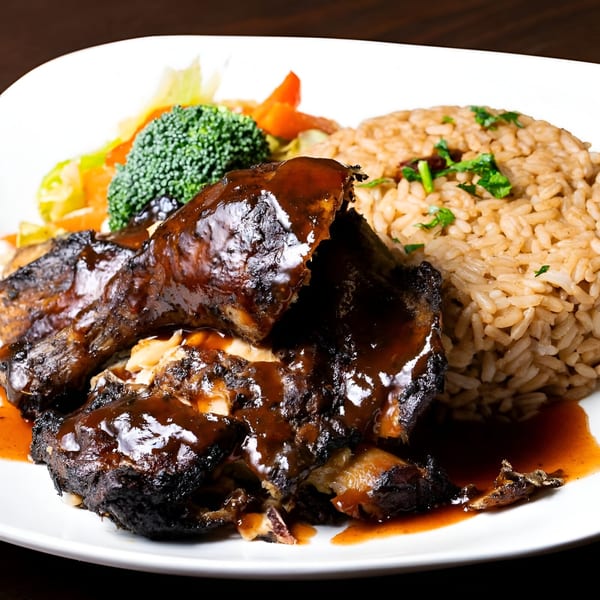 Jamaican jerk chicken with rich brown sauce, rice, and steamed vegetables on a white plate.
