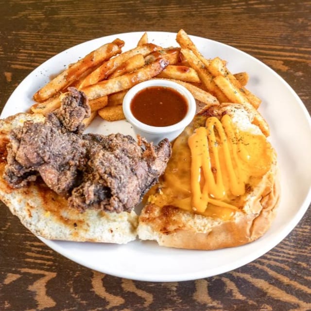 Jamaican fried chicken coco bread sandwich.