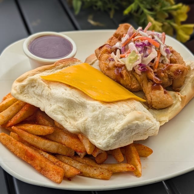 Jamaican fried chicken coco bread sandwich.